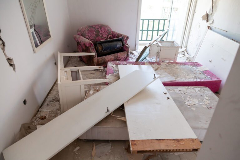 Pieces of broken glass among destroyed furniture and door in an abandoned old hotel rooms. Vandalism and damage Pieces of broken glass among destroyed furniture and door in an abandoned old hotel rooms. Vandalism and damage